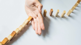 businessman hand stop dominoes continuous toppled or risk with copyspace